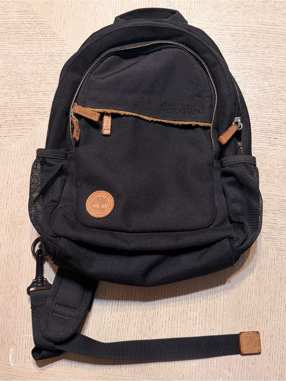 Timberland Black Sling Backpack with Brown Leather Accents